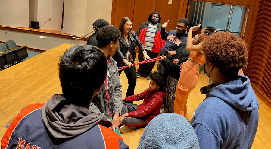 Students using stretch bands in an interactive vocal anatomy exercise led by Beth.