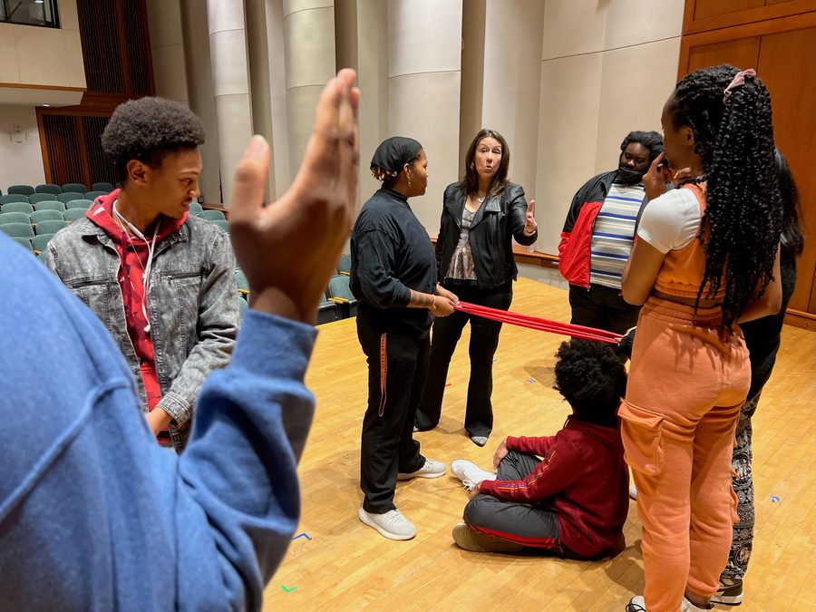 Beth leading a voice masterclass with students on stage at Morgan State University.